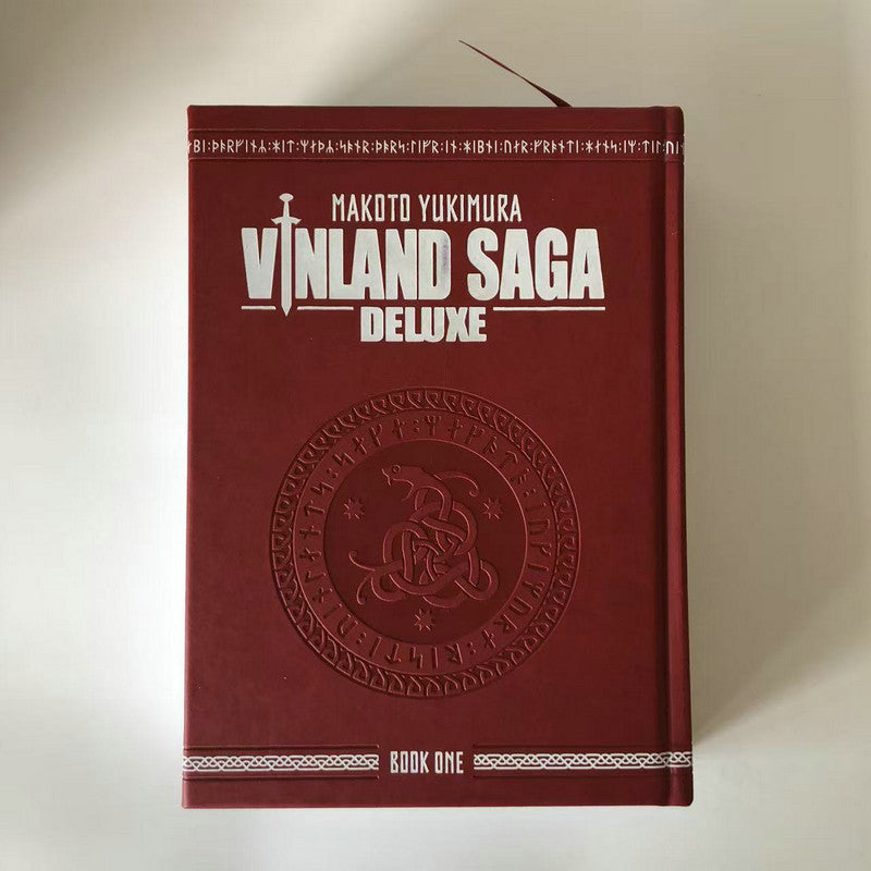 Vinland Saga Deluxe Book One, dark red faux-leather hardcover with embossed Viking rune medallion